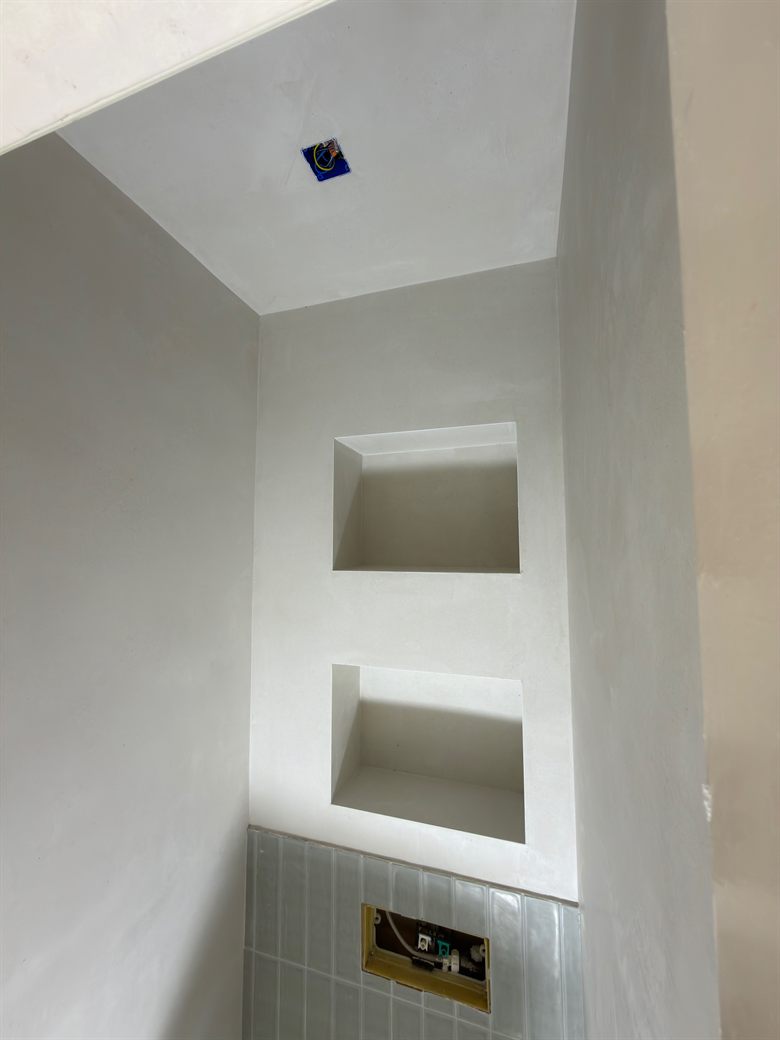 Cementgebonden stucwerk met nissen in badkamer